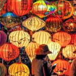 Two Person Standing Near Assorted-color Paper Lanterns